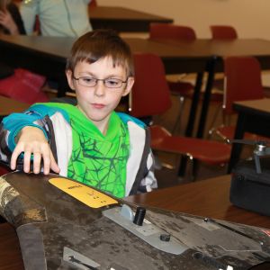 thumbnail image of A kid touching a model airplane