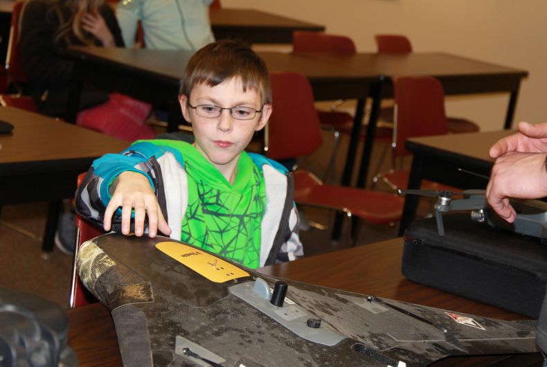 A kid touching a model airplane