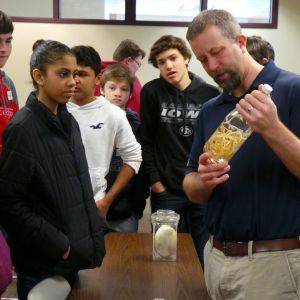 thumbnail image of A man holding a bottle with a mystery substance inside