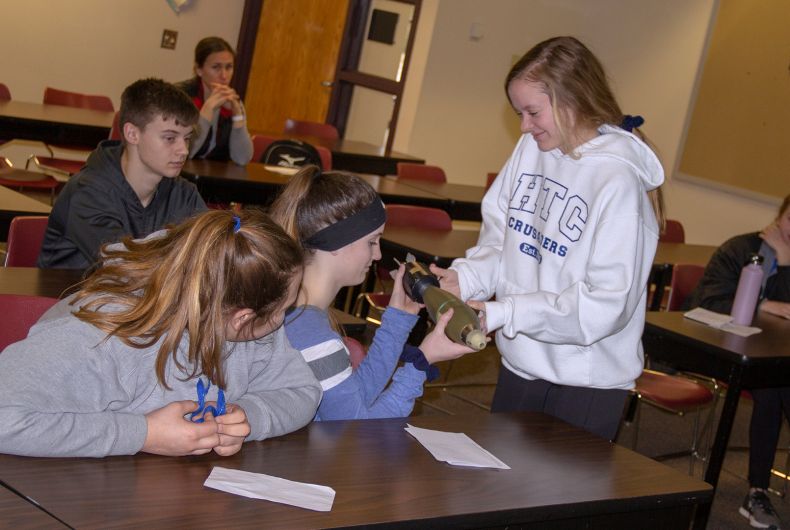 Kids handing off something to each other