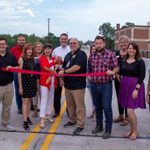 thumbnail image of A group of ambassadors at a ribbon cutting