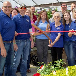 thumbnail image of A group of ambassadors at a ribbon cutting