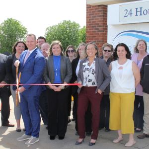 thumbnail image of A group of ambassadors at a ribbon cutting