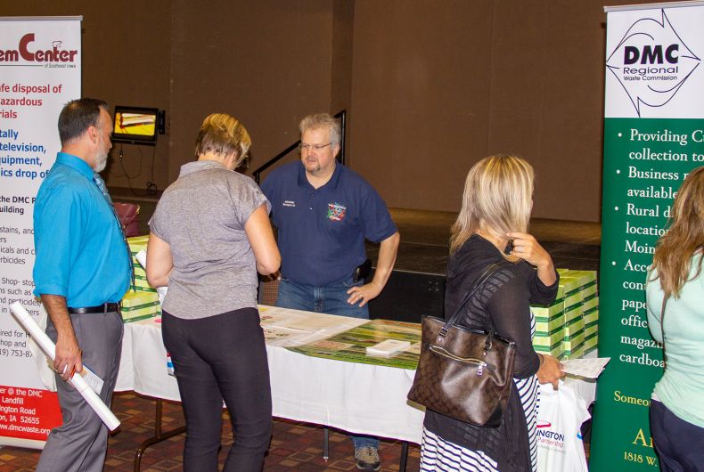 People standing around a booth at the teacher's appreciation