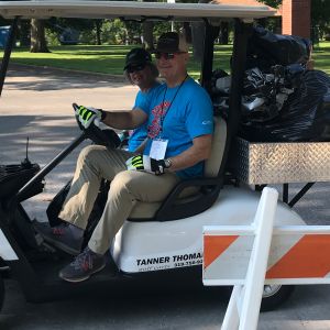 thumbnail image of Volunteers in a golf cart