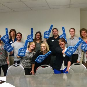 thumbnail image of Volunteers with foam fingers
