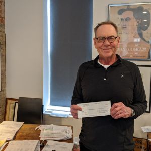 thumbnail image of A man holding a check