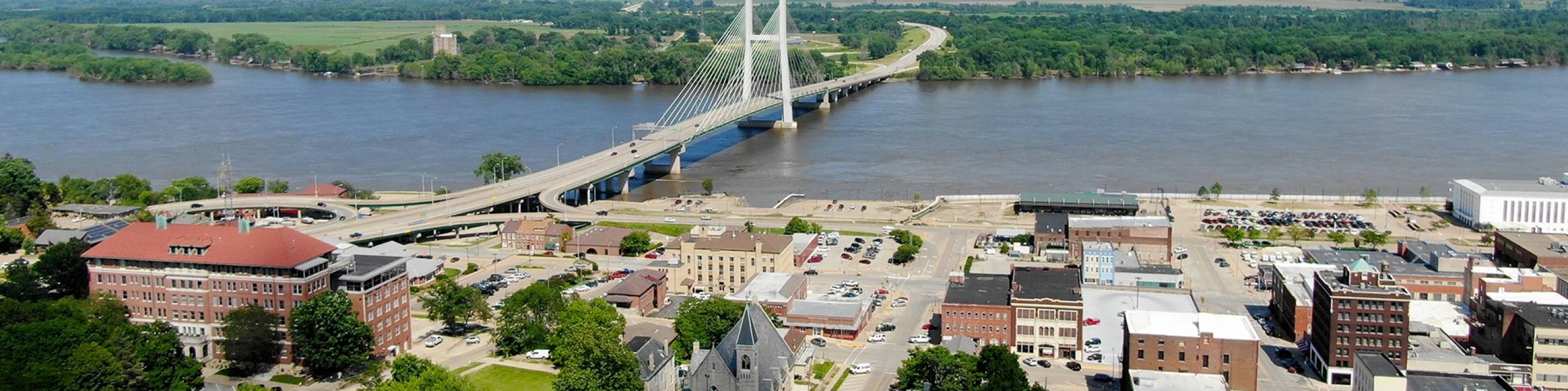 A bridge over a river and a busy town