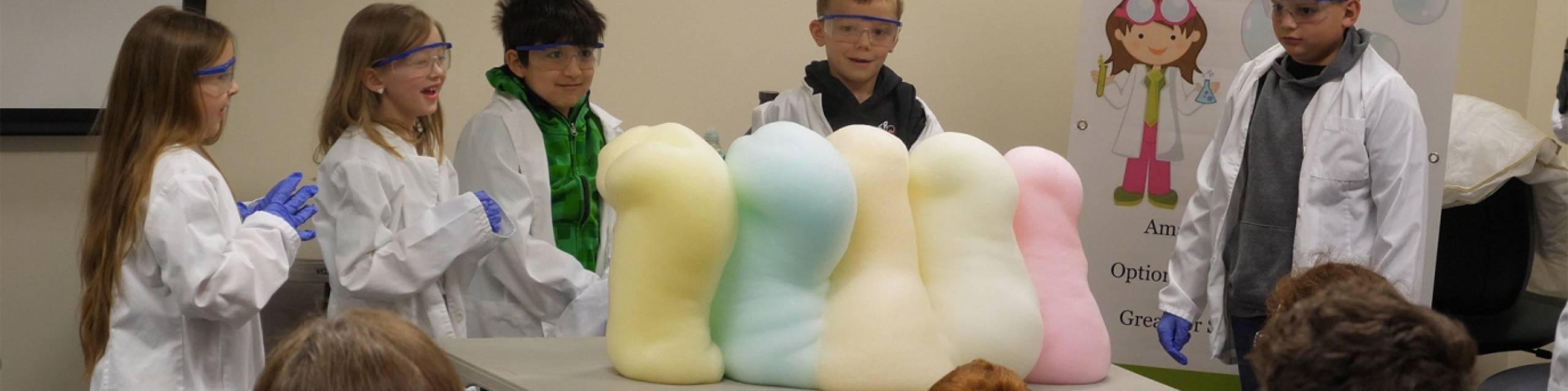 Students in a classroom with colored foam