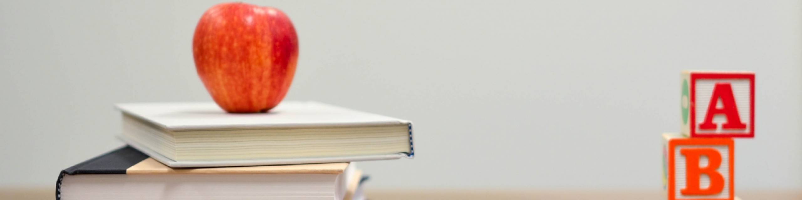 Stack of books with an apple